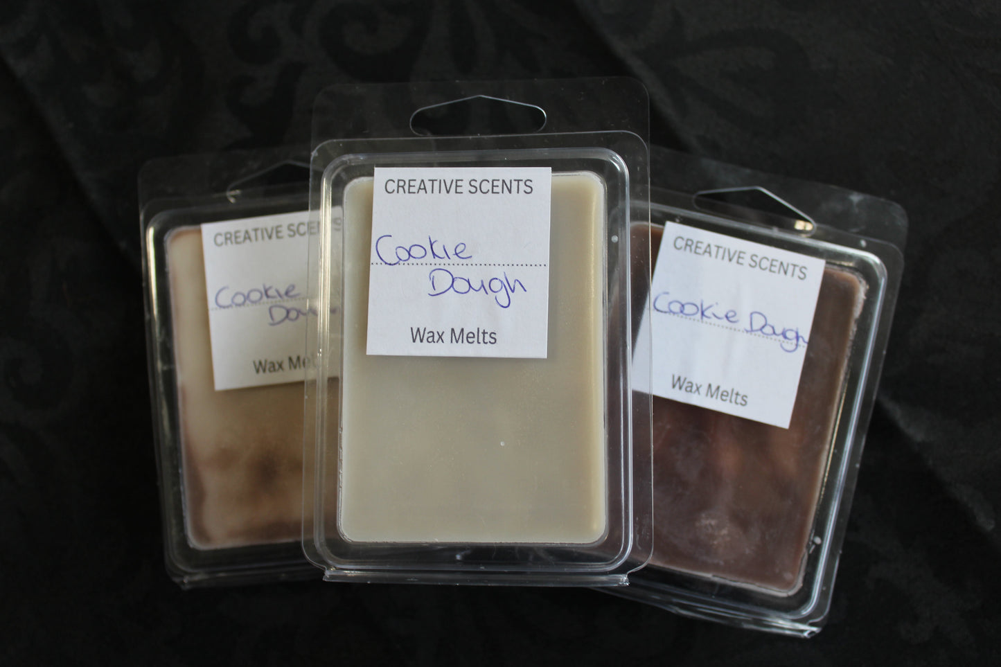 Three packages of Creative Scents Cookie Dough wax melts on a dark background
